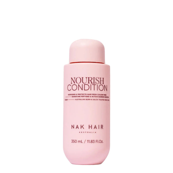 Pink bottle of NAK Hair Nourish Condition on a white background