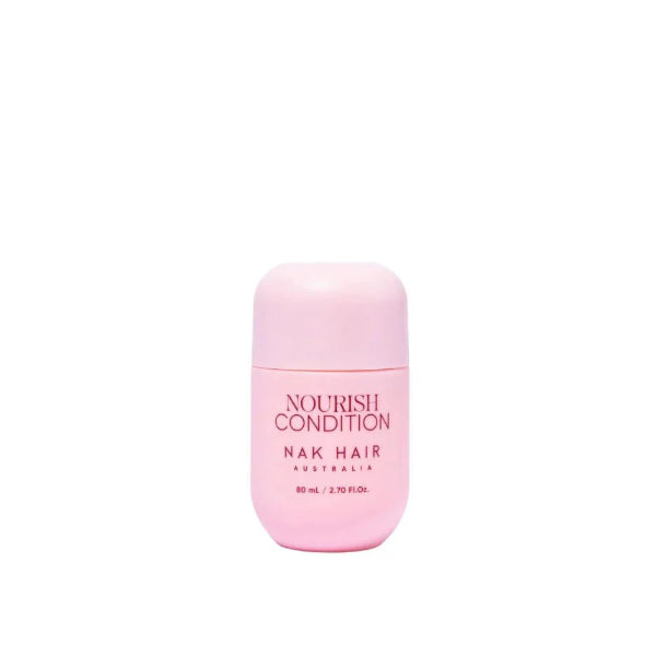 Pink bottle of NAK Hair Nourish Condition on a white background