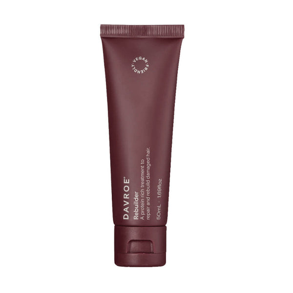 Maroon tube of Davroe Rebuilder hair treatment on a white background