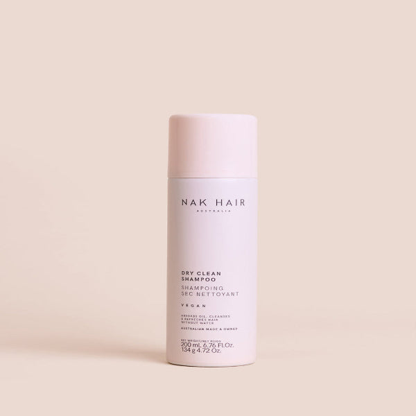 Nak Hair Dry Clean Shampoo bottle on a beige background