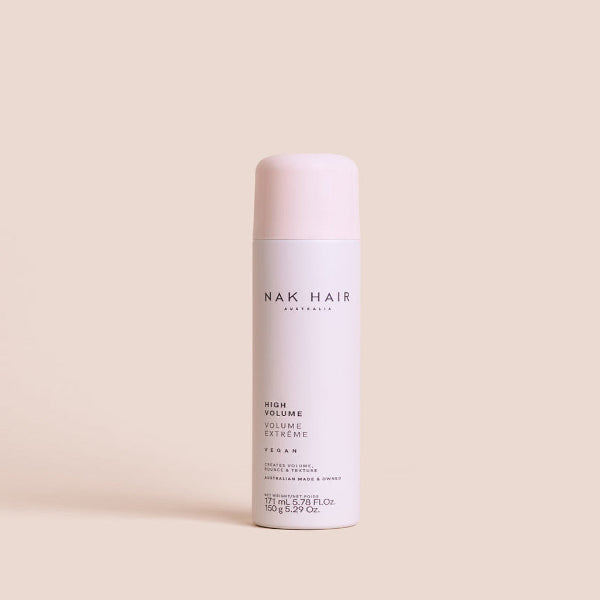 Nak Hair Volume Extreme cream bottle on a beige background
