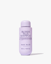 Purple shampoo bottle labeled 'Blonde Plus Shampoo' by NAK Hair on a white background