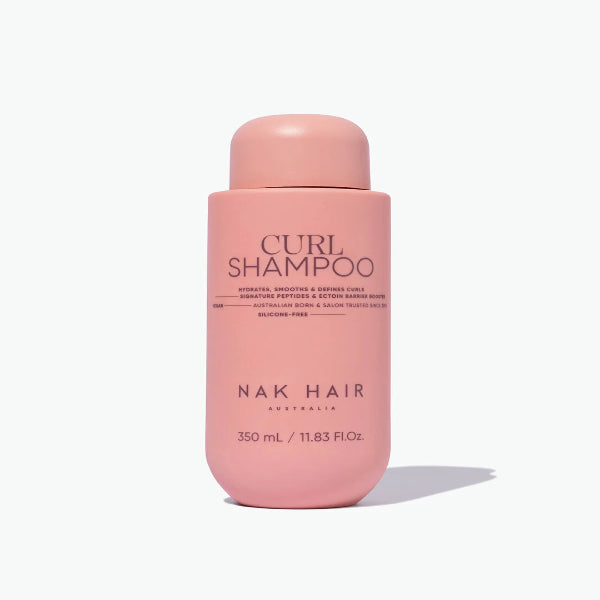Pink shampoo bottle labeled 'Nak Hair' on a white background
