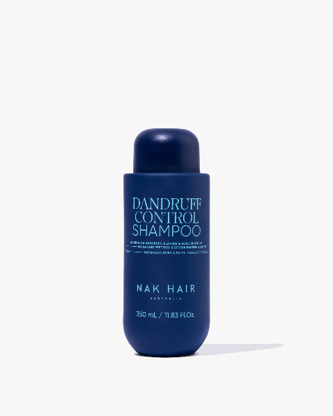 Blue shampoo bottle labeled 'Dandruff Control Shampoo' by NAK Hair on a white background