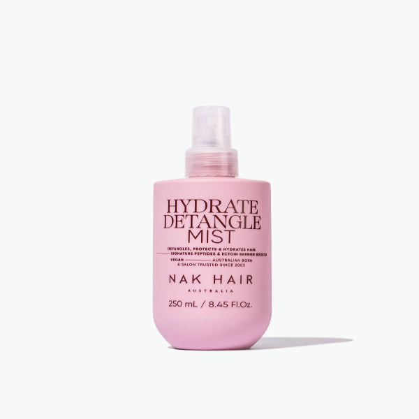 Pink bottle of NAK Hair Hydrate Detangle Mist on a white background