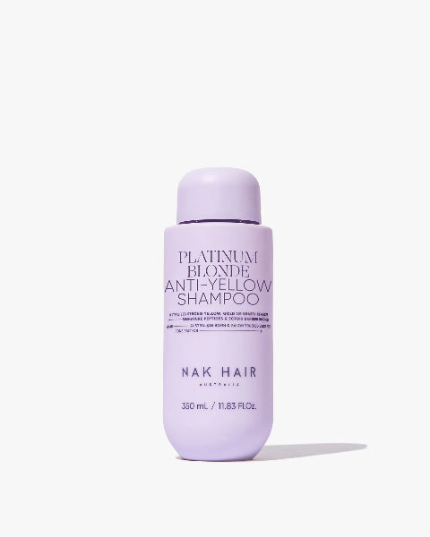 Purple shampoo bottle labeled 'Platinum Blonde Anti-Yellow Shampoo' by Nak Hair on a white background