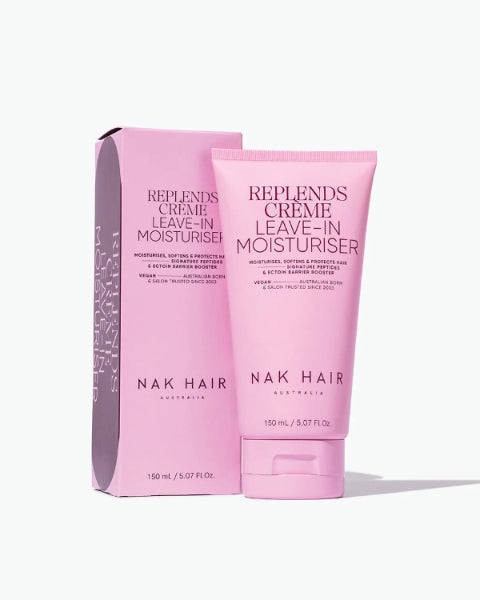 Pink tube and packaging of NAK Hair Replends Crème Leave-In Moisturiser on a white background