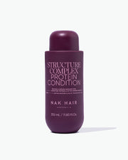 Purple bottle of NAK Hair Structure Complex Protein Conditioner on a white background