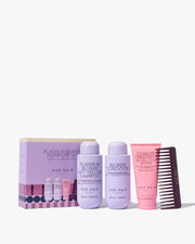 Hair care product set with shampoo, conditioner, and comb on a white background