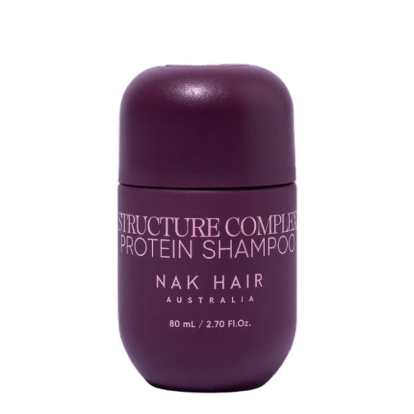 Purple shampoo bottle labeled 'Structure Complex Protein Shampoo' by NAK Hair Australia on a white background