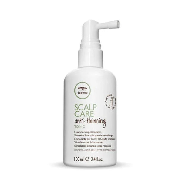 White bottle of scalp care tonic with text on a white background