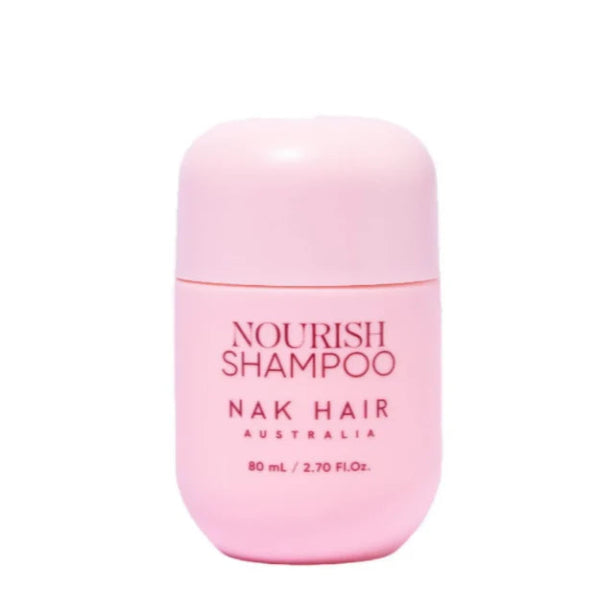 Pink shampoo bottle labeled 'Nourish Shampoo' by 'Nak Hair Australia' on a white background