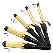 Set of gold and black curling irons with size labels on a white background