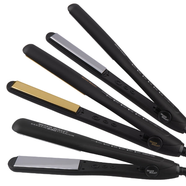 Set of black hair straighteners with gold and silver accents on a white background