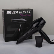 Black hair dryer with 'Silver Bullet' branding next to its packaging on a gray surface.